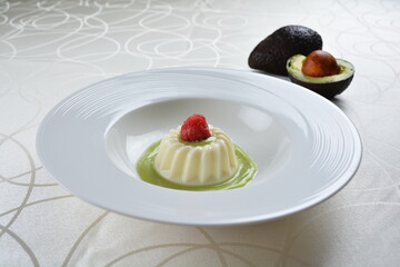 luxury chilled sweet coconut pudding jelly with avocado creamy sauce and raspberry fruit in plate and pink table cloth halal dessert menu