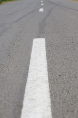 Fototapeta premium marking on the road going into the distance, asphalt road