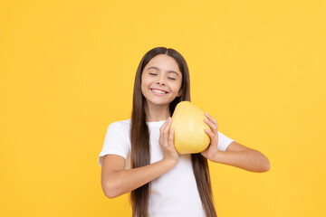 cheerful teen girl hold big citrus fruit of yellow pomelo full of vitamin, healthy food