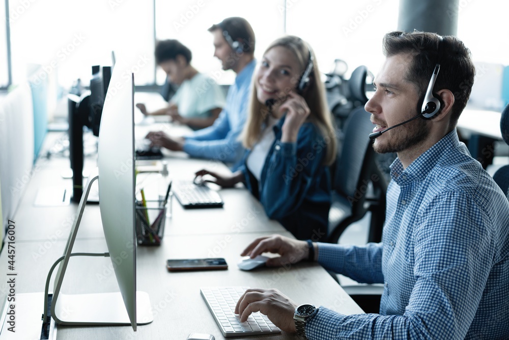 Canvas Prints Young handsome male customer support phone operator with headset working in call center