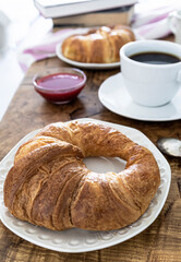 Breakfast with croissants, coffee and fresh fruit. Weekend breakfast. Breakfast and reading on Saturday morning. Lifestyle photography