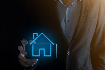 Real estate concept, businessman holding a house icon.House on Hand.Property insurance and security...