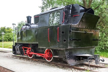 Old retro steam locomotive on rails.