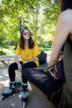 girls talking in the park with skates