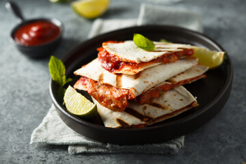 Traditional homemade Mexican quesadilla with tomatoes and cheese