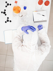 Fototapeta premium Top view of a stressed scientist on the lab table.