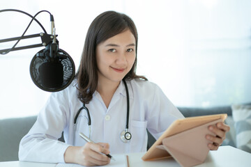 Asian doctor making an online video conference with her patient.