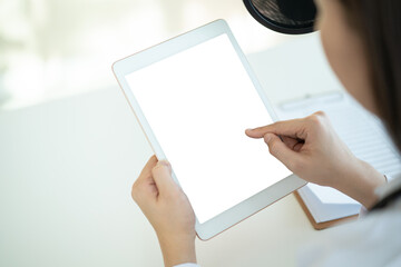 Mockup isolated with clipping path blank screen of tablet. Doctor showing and pointing on tablet.