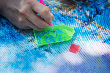 Diamond mosaic painting, Diamond mosaic, fragment of painting close-up, handmade hobby.