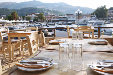 empty waterfront cafe and serving tables