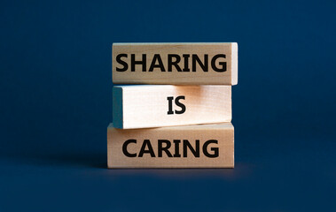 Sharing is caring symbol. Wooden blocks with words 'Sharing is caring' on beautiful grey...