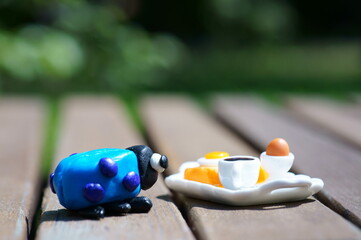 A figurine of a ladybug made of plasticine and a breakfast tray. Close-up.