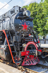 Fototapeta premium Black retro steam locomotive on the railway platform of the Rizhsky station. Moscow, Russia