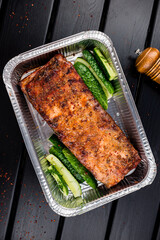 BBQ grilled ribs in a metal tray for delivery. Take out concept, eating at home