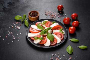 Italian caprese salad with sliced tomatoes, mozzarella cheese, basil, olive oil