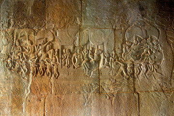 The low relief carvings surrounding Angkor Wat belong to the Khmer Empire. Located in the center of Angkor Thom