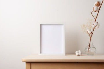 Home decoration with white mock up frame on table. Artwork showcase. Scandinavian style, copy space