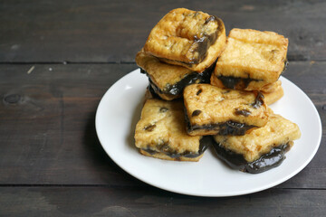 Tahu petis is Javanese traditional snack made from fried tofu with black shrimp paste or petis.