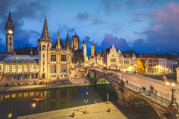 Fototapeta na wymiar High point of view of Medieval city of Gent in Flanders with Saint Nicholas Church and Gent Town Hall, Belgium. Sunset cityscape of Gent.