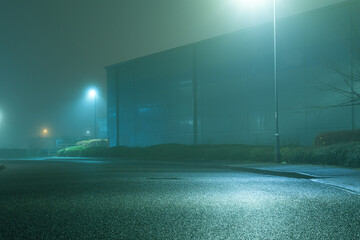 A road and light industrial units, on a foggy, spooky, atmospheric winters night.