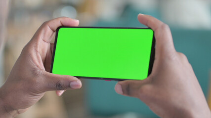 Close up of African Hands Holding Smartphone with Green Screen 
