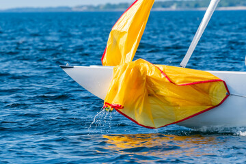 wet sail on the bow of the yacht