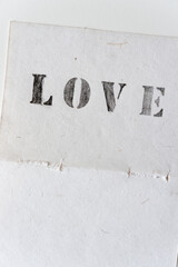 stencil font love on fancy torn paper