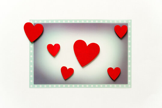themed photo overlay with six hand-painted wooden hearts on a light background and plenty of space for copy or text