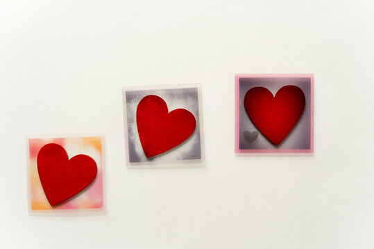 three themed photo overlays with hand-painted wooden hearts on a light background and plenty of space for copy or text