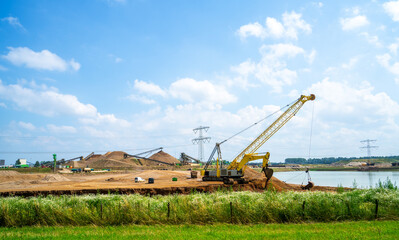 Fototapeta premium Sand extraction from the river bank (river Meuse, Netherlands) 