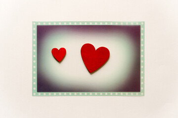 themed photo overlay with two hand-painted wooden hearts on a light background with plenty of space for copy or text