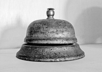 old rusty bell on wooden counter