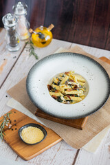 Penne mushroom with Cream Sauce and spiach bacon on wooden board