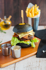 Beef burger cheese volcano with chips on wooden board