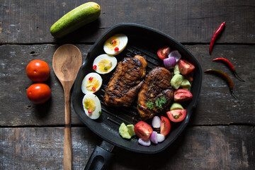 Chicken steak and vegetable saute in a pan with use of selective focus 
