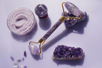 Amethyst crystals Gua sha roller massage scraper and beauty product. Moisturizer and skincare...