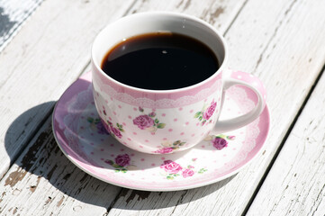 Coffee cup on peeling white wood