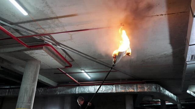 Check of automatic work of fire extinguishing of underground parking. Explosion of a fire extinguishing cartridge. Water flowing through the nozzle.