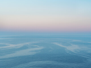 Delicate clear dawn over the sea. Beautiful minimalistic background at pastel gradient colors
