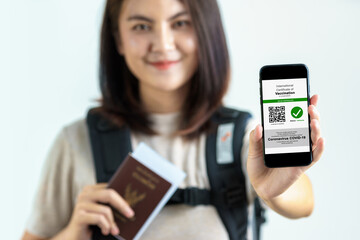 Disease immunity passport, Tourist uses of application on smartphone to show an international...