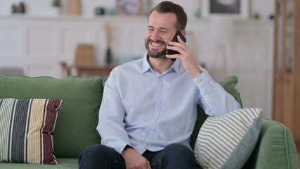 Young Man Talking on Phone at Home