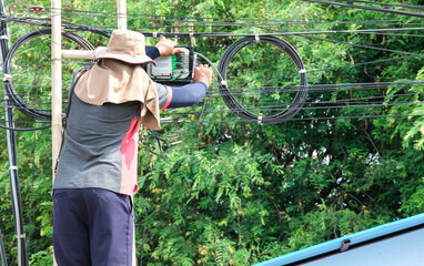 service man climbing bamboo stair wooden for service maintenance upgrade speed fiber optic line. ...