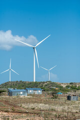 dramatic image of wind turbine and turbines on the caribbean desert coast of the dominican...
