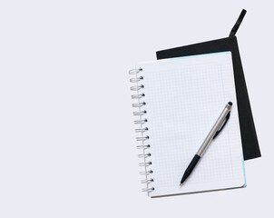 white notebook with clean papers and silver pen on the white background