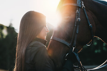 Beautiful young woman enjoying with her horse.	