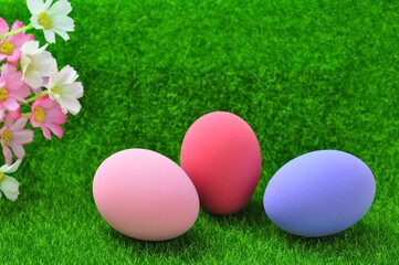 Fototapeta na wymiar sweet easter eggs on green grass on natural light background