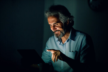businessman laptop tablet night business computer man senior mature old elderly office technology...