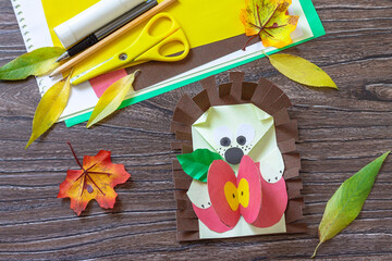 Autumn Greeting postcard hedgehog with an apple on a wooden table. Handmade. Project of children's...