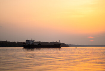 big/small boat at sunset