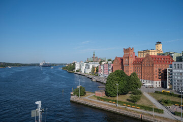 Large blue cruise ship in the Stockholm on it its way through the archipelago passing the water front of the district Nacka